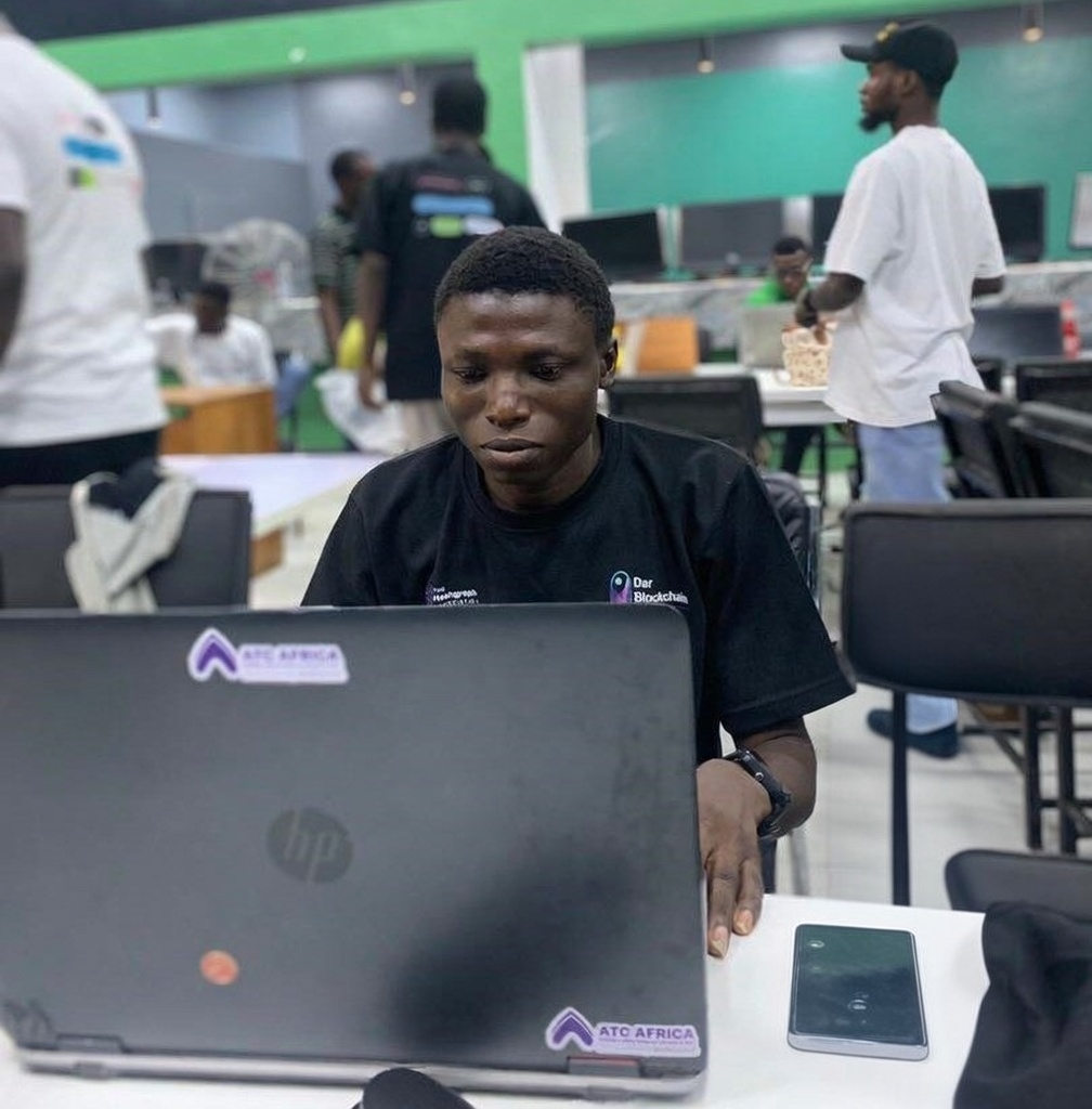 Sanusi Emmanuel Femi working on his laptop